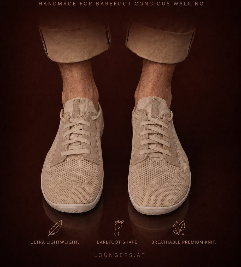 A pair of beige knit lounge sneakers shown on a person's bare feet, with rolled-up tan pants visible against a dark brown background. Large text at the top reads 'LOUNGERS' and smaller text includes 'HANDMADE FOR BAREFOOT CONCIUS WALKING' and feature callouts near the bottom.