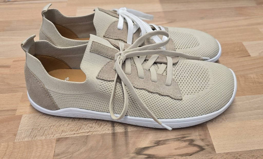 Men's beige Vector Barefoot shoes by LOUNGERS, featuring a minimalist design and natural-looking soles, displayed on a plain background.