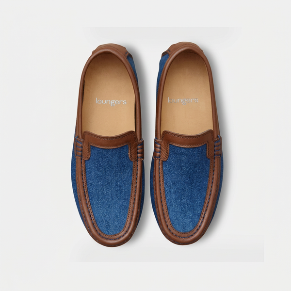Women's denim driving shoes with brown leather trim, top view on a light grey background.